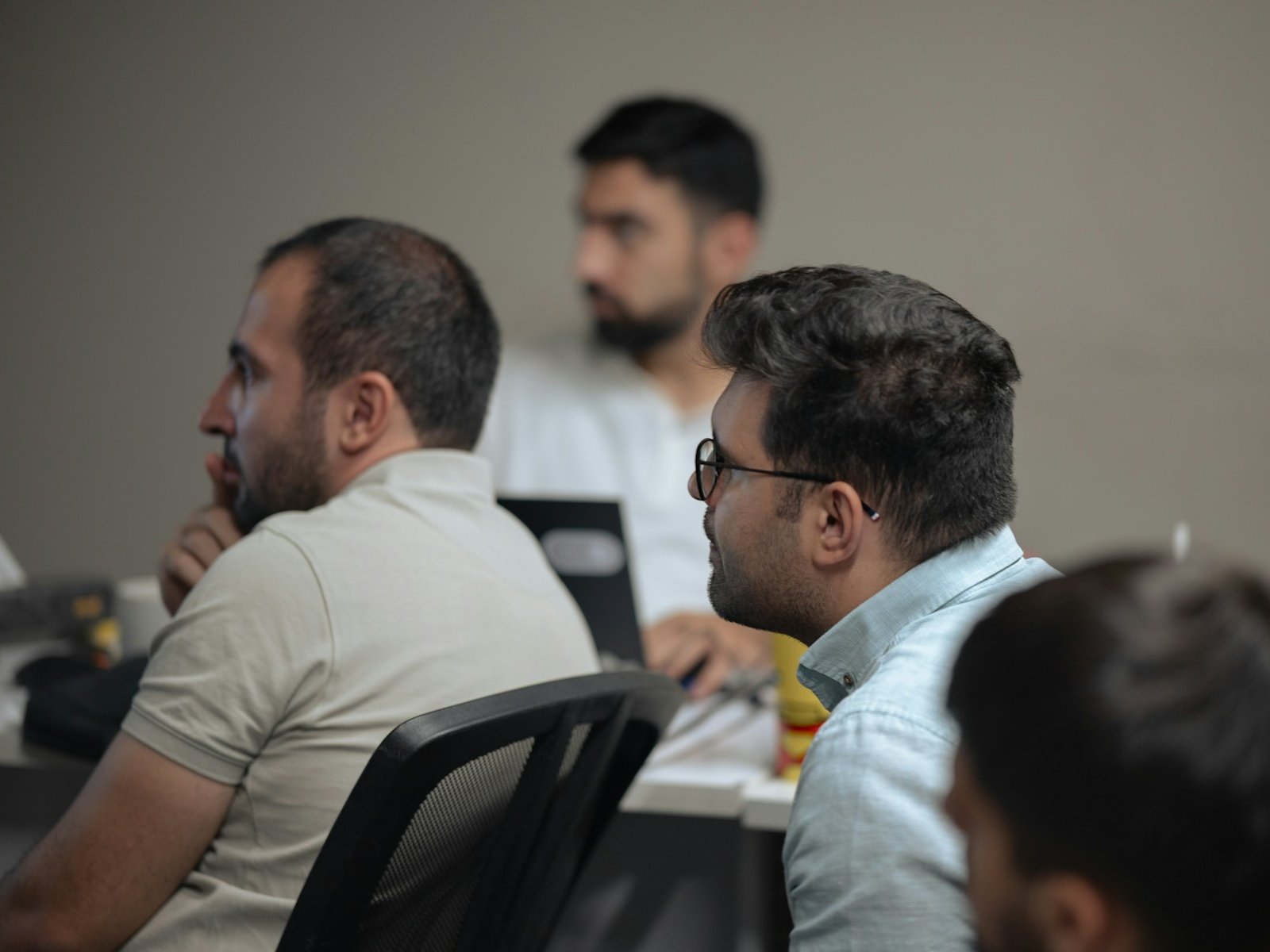 Training cohort working at laptops during a session